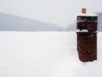 snow covering rooftop and chimney